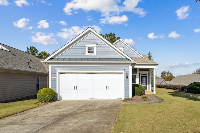 view of front facade with a standing seam roof, concrete driveway, metal roof, and a front lawn