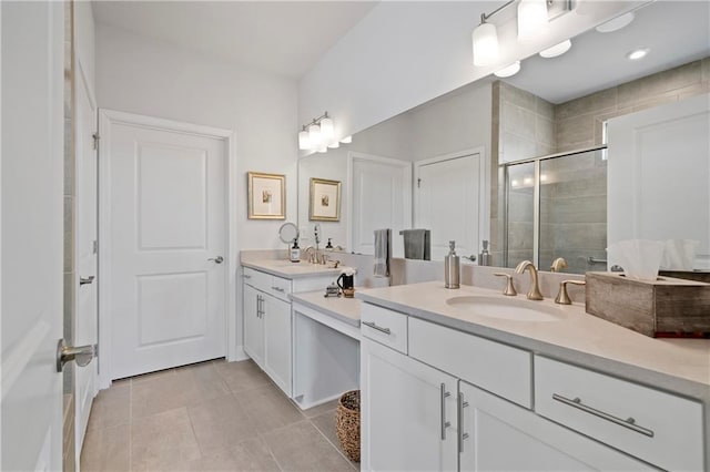 full bath with double vanity, tile patterned flooring, a sink, and a shower stall