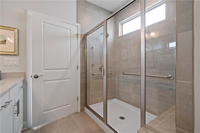 bathroom with a shower stall, vanity, and tile patterned floors