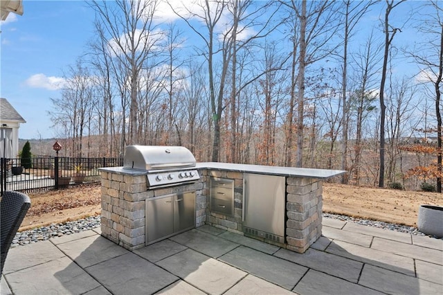 view of patio featuring area for grilling, grilling area, and fence