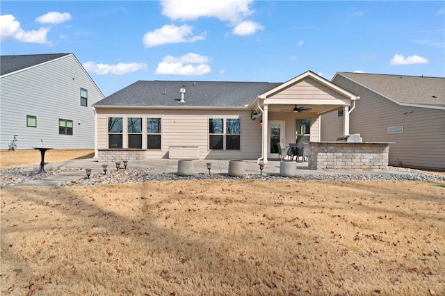 rear view of house with a patio area, ceiling fan, and exterior kitchen