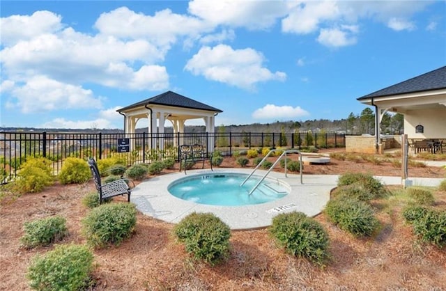 view of swimming pool featuring fence and a gazebo