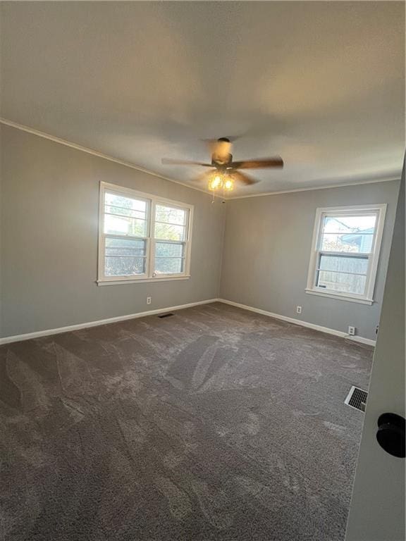 carpeted empty room featuring ceiling fan and ornamental molding