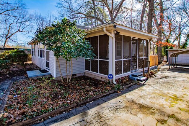 view of front of home with a sunroom and a wooden deck