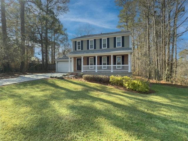 colonial home with a porch, a garage, and a front yard