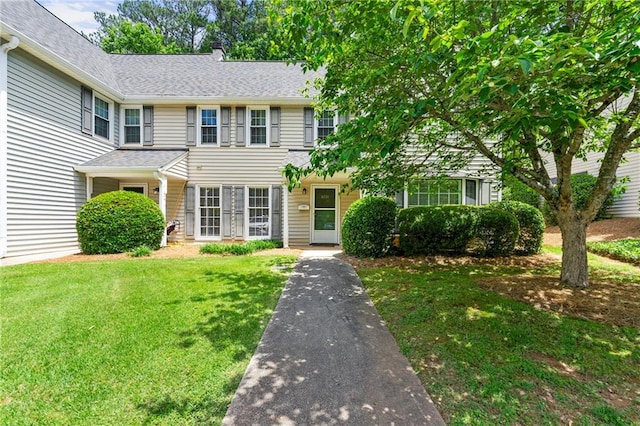 4131 N Gloucester Pl, Atlanta, GA 30341 - view of front of house with a front lawn, a chimney, and roof with shingles