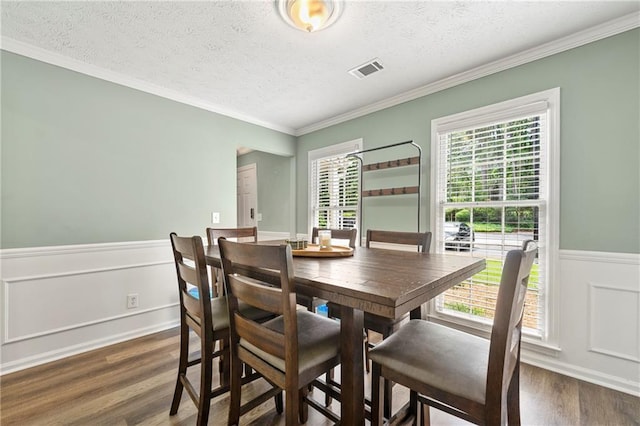 4131 N Gloucester Pl, Atlanta, GA 30341 - dining room featuring wood finished floors, a textured ceiling, crown molding, and wainscoting