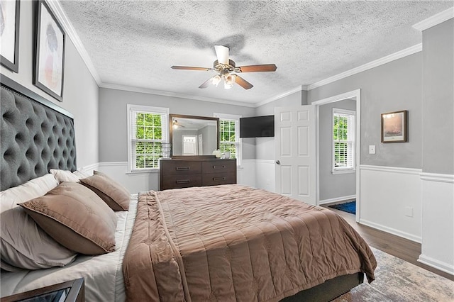 4131 N Gloucester Pl, Atlanta, GA 30341 - bedroom featuring wood finished floors, a ceiling fan, a textured ceiling, and ornamental molding