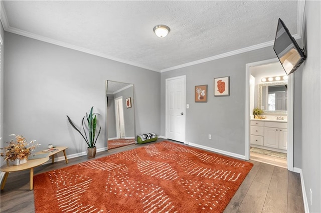 4131 N Gloucester Pl, Atlanta, GA 30341 - unfurnished bedroom with wood-type flooring, ornamental molding, baseboards, a textured ceiling, and ensuite bath