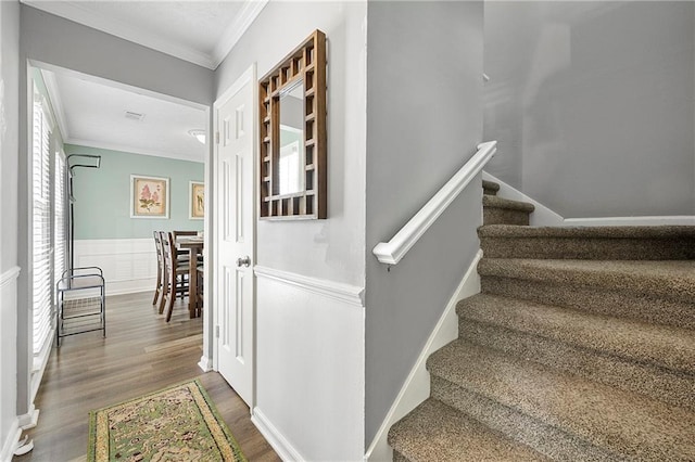 4131 N Gloucester Pl, Atlanta, GA 30341 - staircase featuring crown molding, wood finished floors, and wainscoting