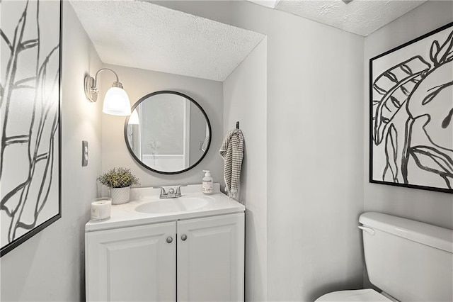 4131 N Gloucester Pl, Atlanta, GA 30341 - bathroom featuring a textured ceiling, toilet, and vanity