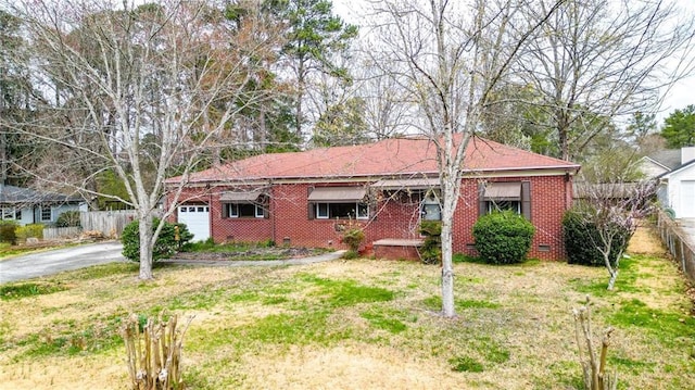 ranch-style house with a garage, aphalt driveway, fence, crawl space, and brick siding