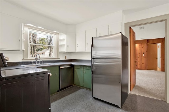 kitchen with green cabinetry, a sink, appliances with stainless steel finishes, white cabinetry, and dark countertops