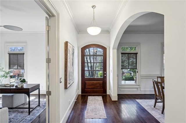 entryway featuring a wealth of natural light, crown molding, and dark hardwood / wood-style flooring