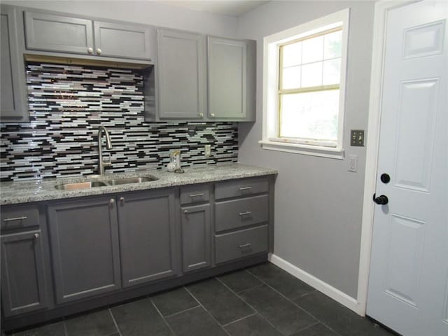 3086 Lone Oak Ave SW, Atlanta, GA 30354 - kitchen featuring gray cabinetry, a sink, and backsplash