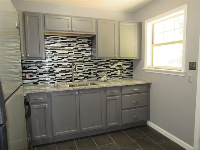 3086 Lone Oak Ave SW, Atlanta, GA 30354 - kitchen with gray cabinetry, a sink, tasteful backsplash, and dark tile patterned floors