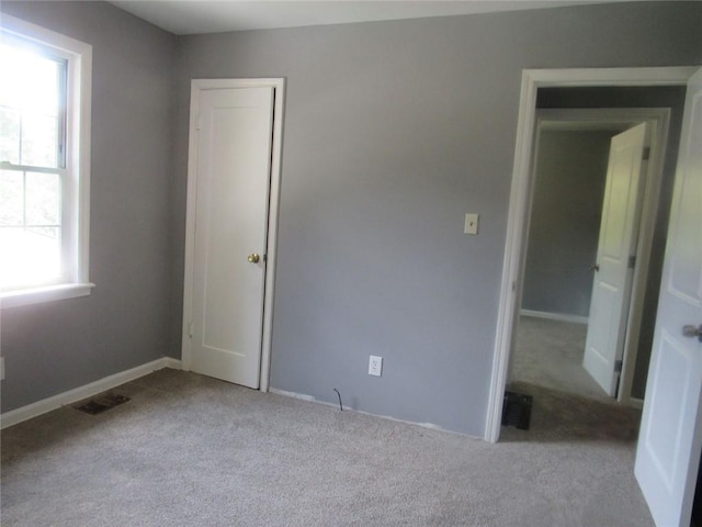 3086 Lone Oak Ave SW, Atlanta, GA 30354 - unfurnished bedroom with carpet, baseboards, and a closet