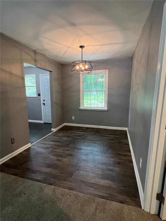 3086 Lone Oak Ave SW, Atlanta, GA 30354 - unfurnished dining area featuring a chandelier, baseboards, and wood finished floors