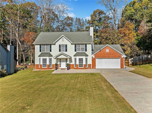 view of front of house featuring a front lawn and a garage