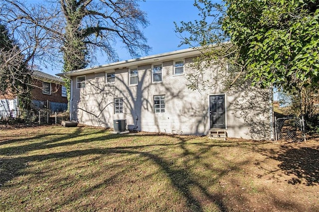 back of house featuring a yard and cooling unit