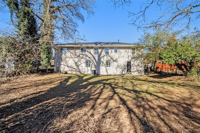 rear view of house featuring a yard