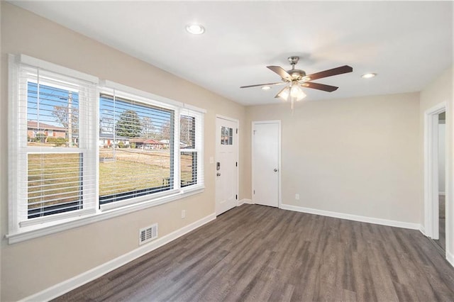 unfurnished room featuring dark hardwood / wood-style floors and ceiling fan