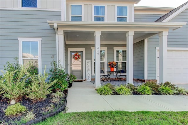 entrance to property with a garage and a porch