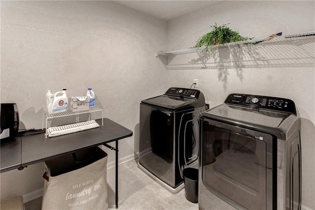 clothes washing area featuring washer and clothes dryer