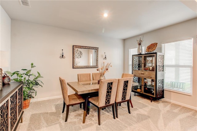 dining area with a healthy amount of sunlight and light colored carpet