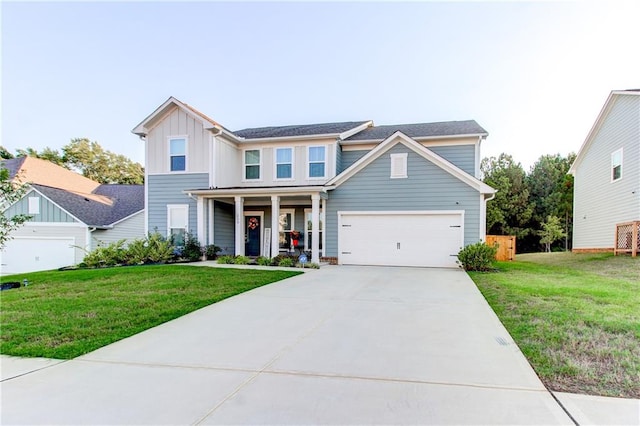 view of front of property featuring a front yard and a garage