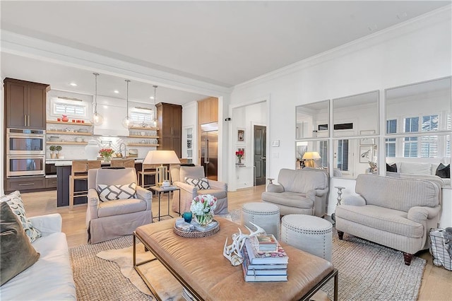 living room with light hardwood / wood-style flooring and ornamental molding