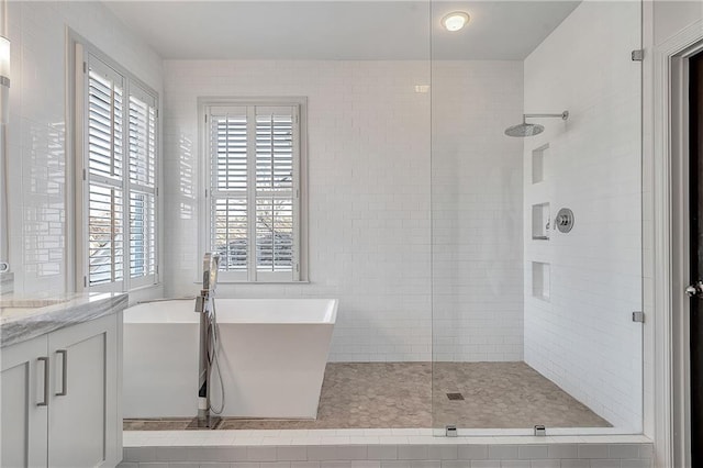 bathroom with vanity and separate shower and tub