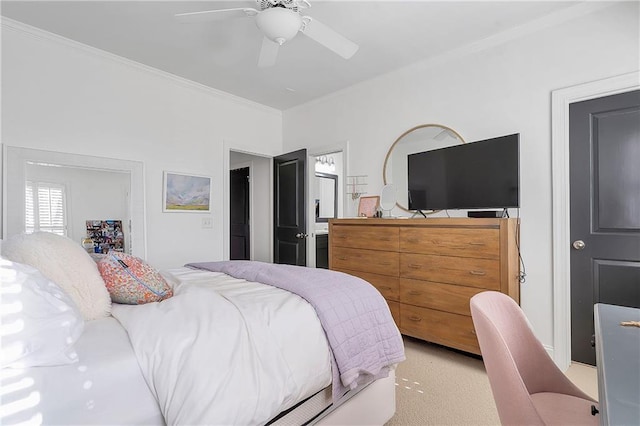 carpeted bedroom with ceiling fan and ornamental molding