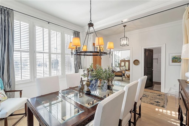 dining space featuring crown molding and light wood-type flooring