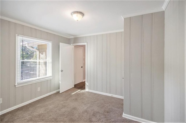 carpeted empty room featuring ornamental molding