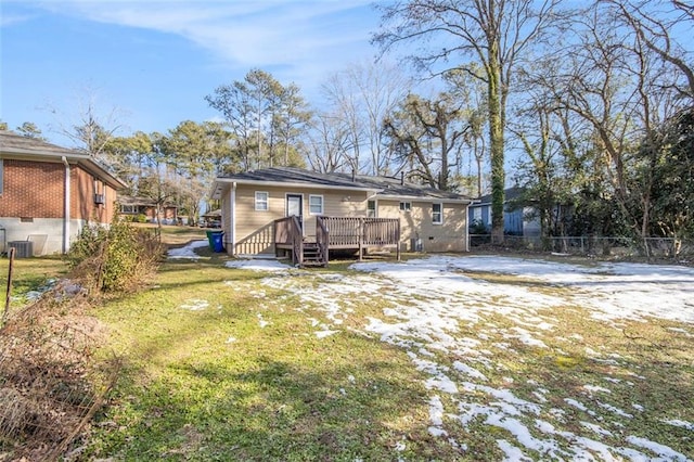 rear view of house with a yard and a deck