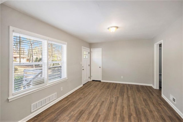 empty room with dark wood-type flooring