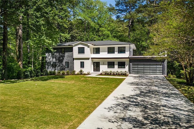 view of front of house with a garage and a front lawn