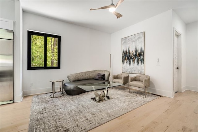 living room with ceiling fan and light hardwood / wood-style floors