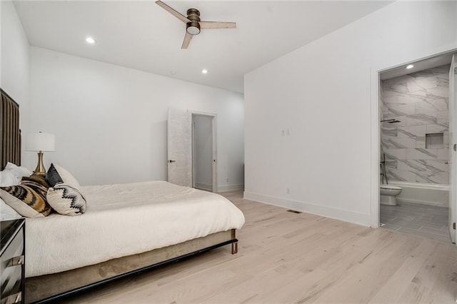 bedroom featuring ensuite bathroom, light wood-type flooring, and ceiling fan