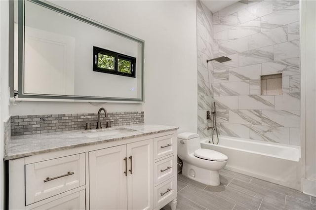 full bathroom with vanity, tile patterned floors, tiled shower / bath, and toilet