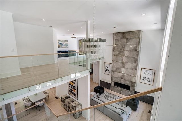 interior space with a tiled fireplace and wood-type flooring