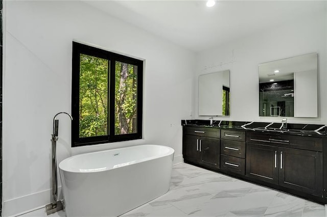 bathroom featuring dual vanity, tile patterned floors, and a bathing tub