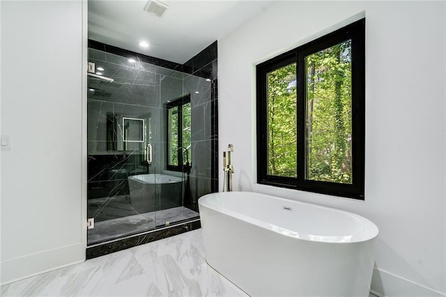 bathroom with shower with separate bathtub, tile patterned flooring, and a wealth of natural light