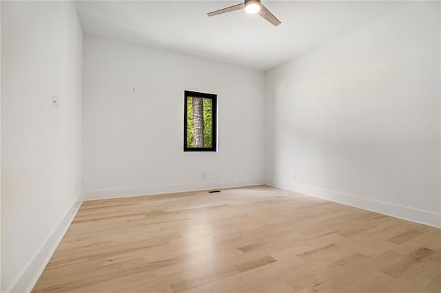 empty room with light wood-type flooring and ceiling fan