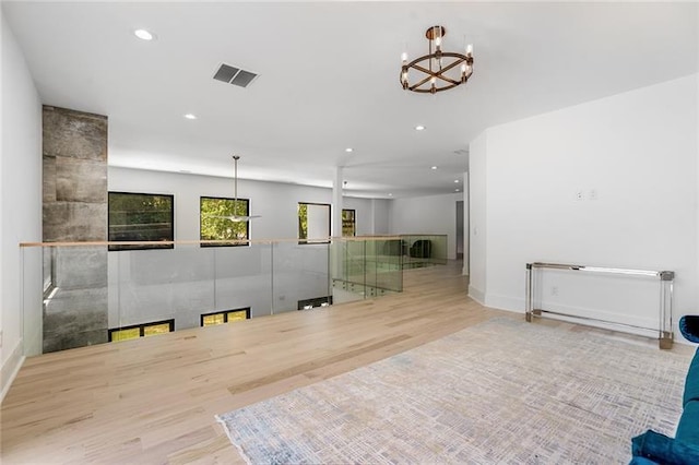 interior space with an inviting chandelier and light wood-type flooring