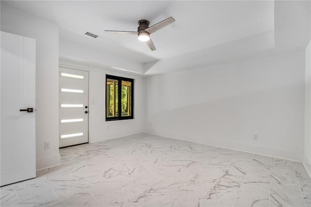 tiled spare room with ceiling fan