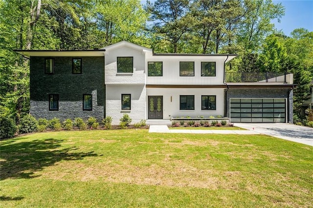 view of front of home with a garage and a front yard