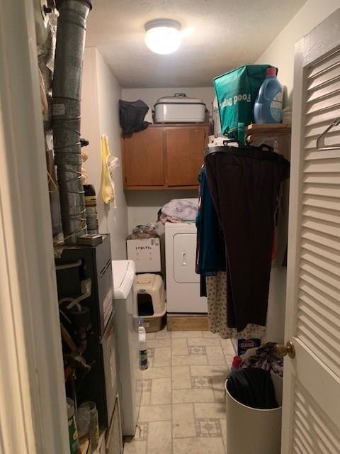 washroom with cabinet space and separate washer and dryer