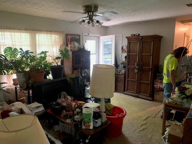 misc room with carpet and a ceiling fan
